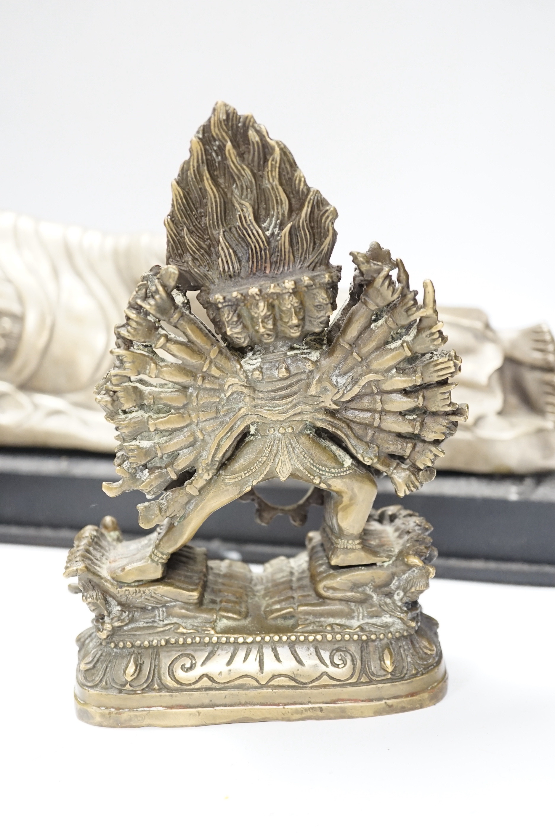 Three bronze and other metal figures of the Buddha and a Tibetan figure of Yamantaka, tallest 21.5cm